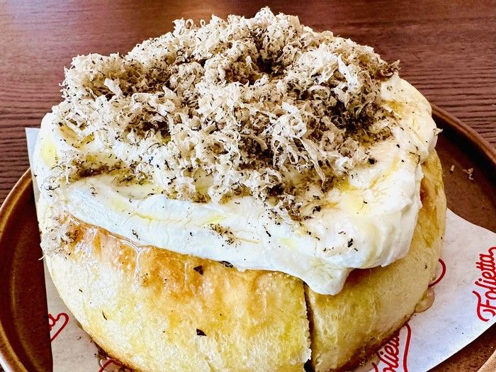 On the Folietta menu: Focaccia, topped with bright, fresh ricotta, a showering of black truffle bits, and drizzles of olive oil.