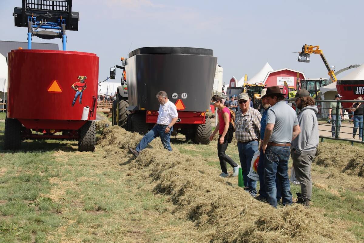 People look at feed at the Total Mixed Ration Demo at Ag in Motion 2025