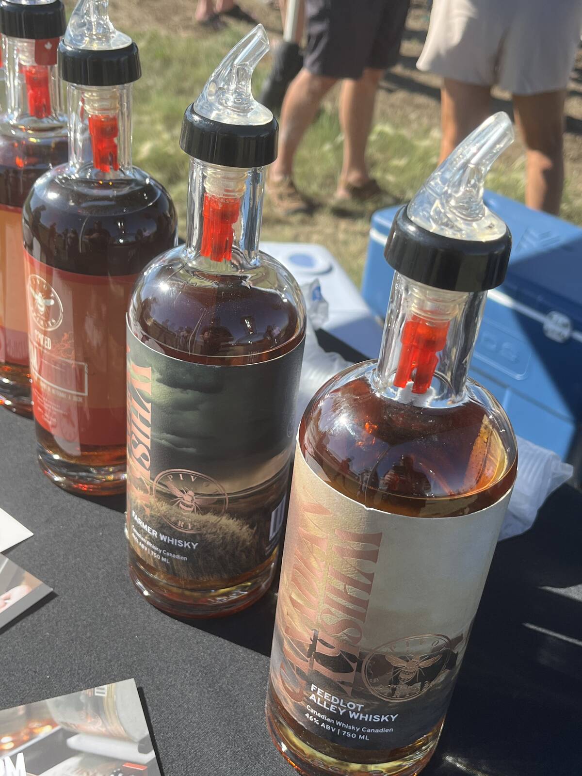 A close-up of several of the bottles containing red whisky distilled by Pivot Spirits.