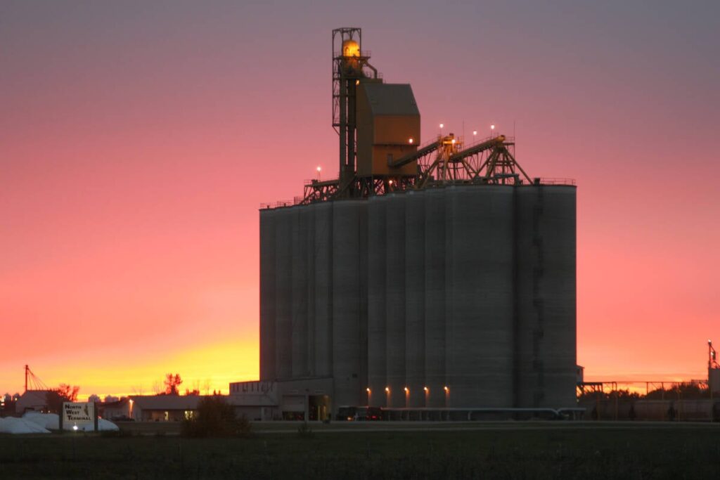 The North West Terminal in Unity, Sask., silhouetted against a reddish sky near sunset.