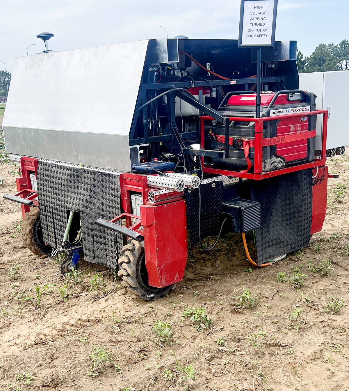 The 1.2 ton BHF ElectricWeeder, an Ontario-made and developed weather resistant autonomous robot, sits on display at a field day.