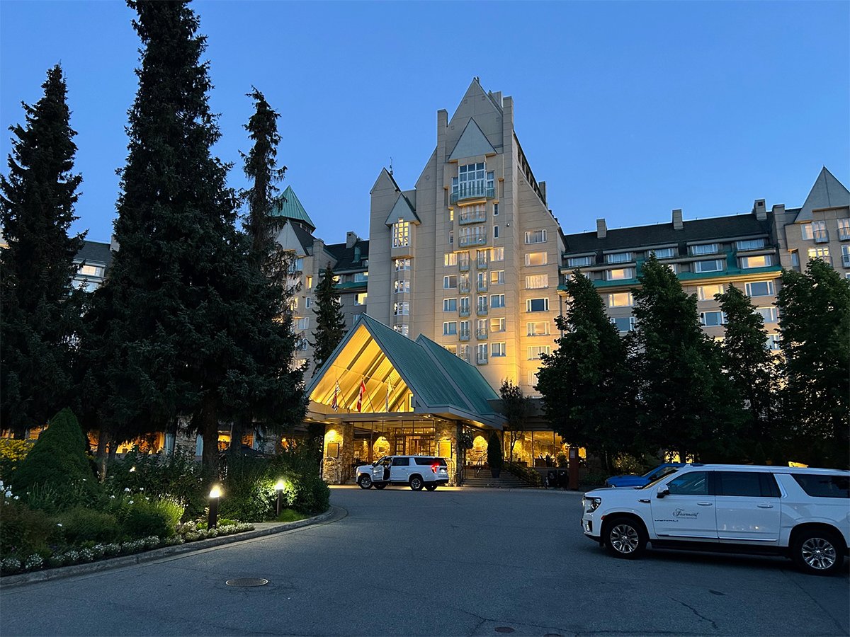 The grand entrance of the Fairmont Chateau Hotel in Whistler, B.C., at dusk.