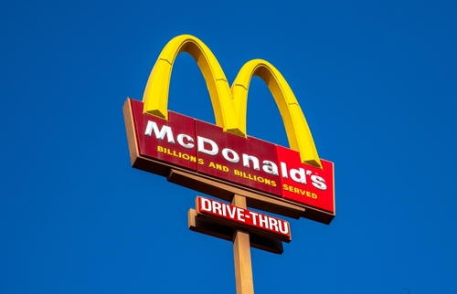 A McDonald's sign set against the backdrop of blue sky