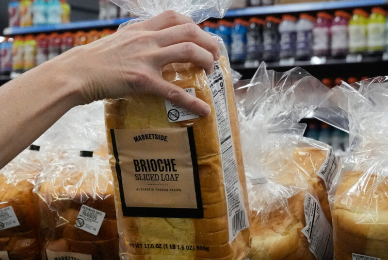 A customer reaches for a loaf of Marketside brand bread at a Walmart Neighbourhood Market, Friday, Sept. 26, 2025, in Bentonville, Ark. (AP Photo/Charlie Riedel)