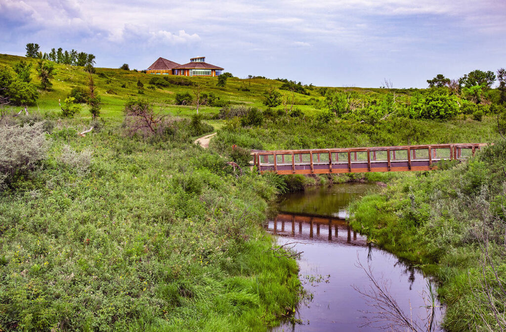 Opimihaw Creek, with a small bridge across it, in Wanuskewin Heritage Park.