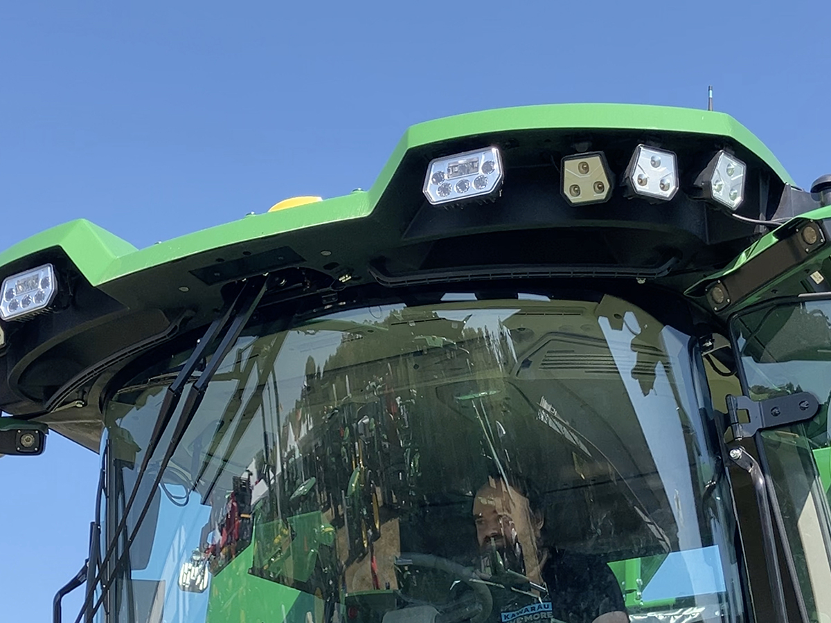 A man sits in the cab of a new John Deere combine on display at Canada's Outdoor Farm Show in Ontario in September, 2025.