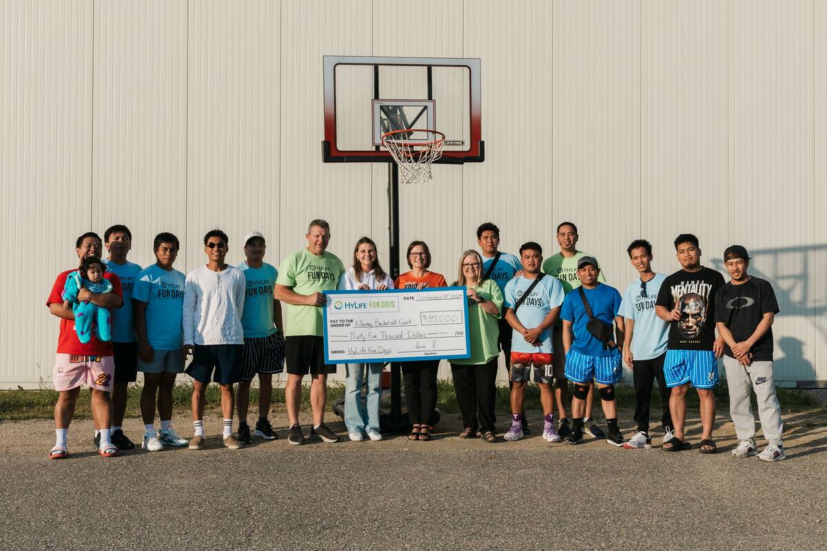 Members of the Killarney Basketball Court Enhancement Project accept a cheque for $35,000 from HyLife Fun Days.