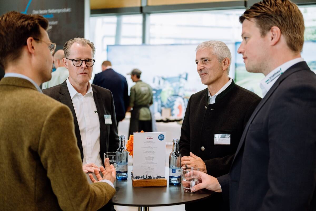 Agco CEO Eric Hansotia (second from right) speaks with guests at the company’s Tech Day in Germany.