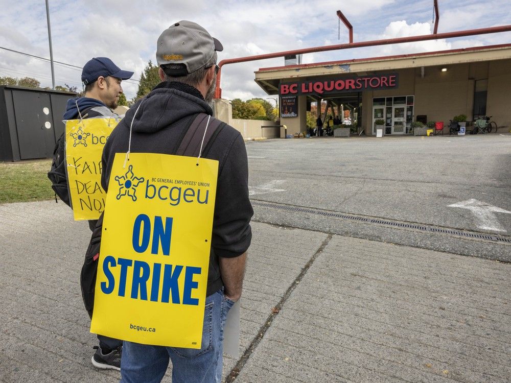 BCGEU members walk the picket line  outside the B.C. Liquor store at Broadway and Lillooet Streets in Vancouver on Oct. 8, 2025. 