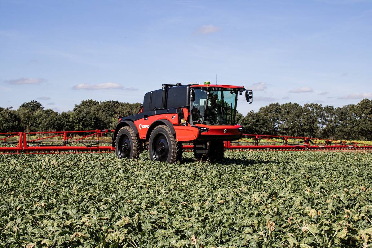 A new Agrifac sprayer sits idle in a lush green crop on a sunny day.