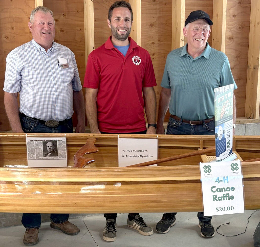 Ontario 4-H Foundation trustee, Bill Zwambag, left, and canoe builder, Ron McRae, right, presented raffle winner Danny Jefferies with the 15 foot handcrafted cedar canoe at the Idlerton Fair on Sept. 28, 2025. The raffle raised $14,580 for the Ontario 4-H Foundation's Stanley Knapp Resource Development Endowment Fund. 