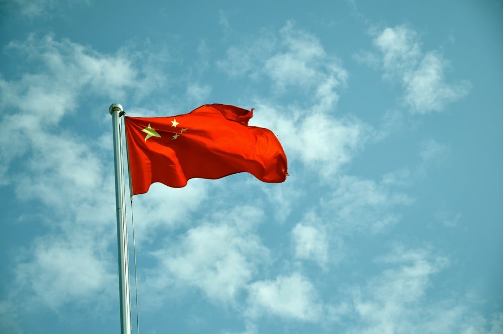 A Chinese flag in a blue sky.