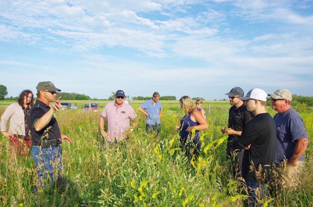 Clayton Robins (left) takes a farm tour through his use of cover cropping on his farm near Rivers, Manitoba.