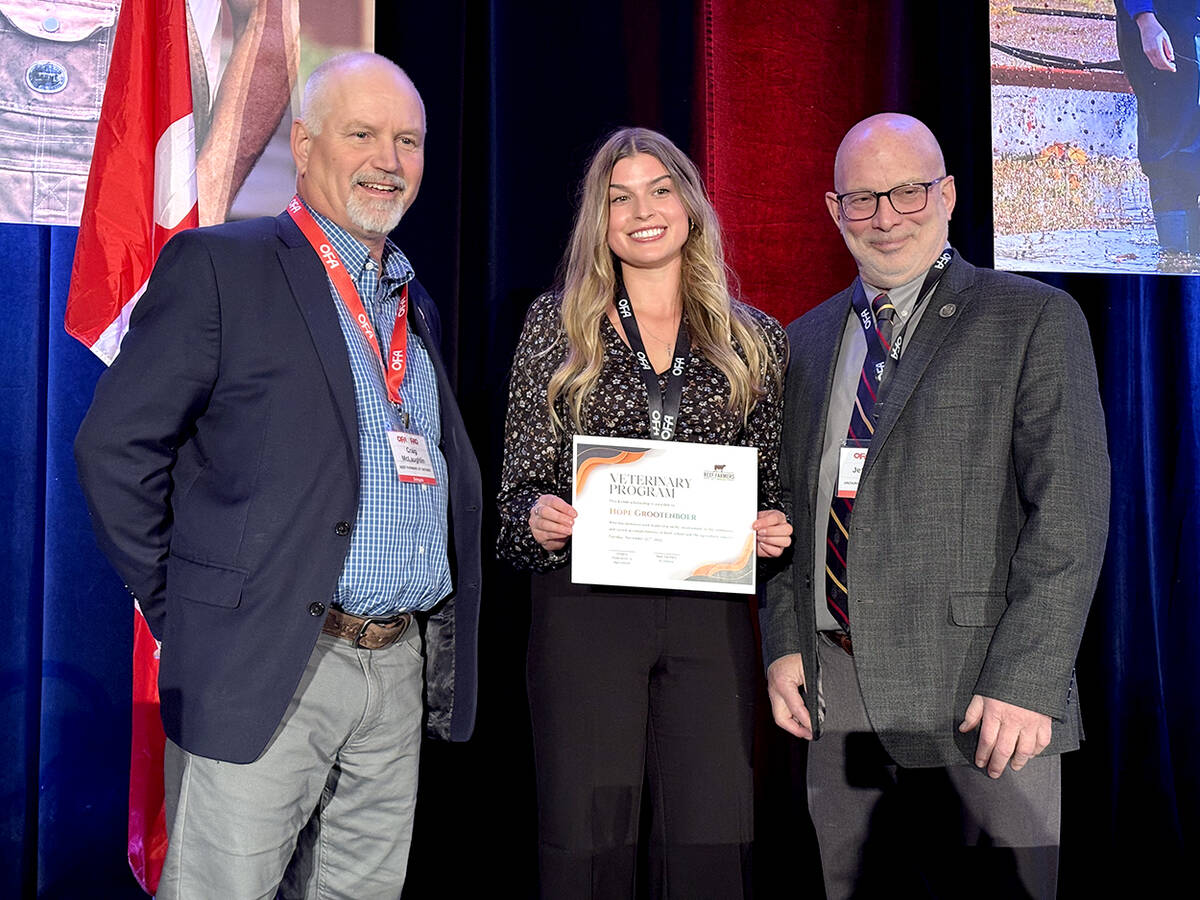 Beef Farmers of Ontario president, Craig McLaughlin, left, and Jeff Wichtel, Dean of Ontario Veterinary College, University of Guelph, right, present veterinarian student Hope Grootenboer, County of Thunder Bay, centre, with a $2,000 grant during the Ontario Federation of Agriculture's annual general meeting, Nov. 25, 2025. Photo: Diana Martin 