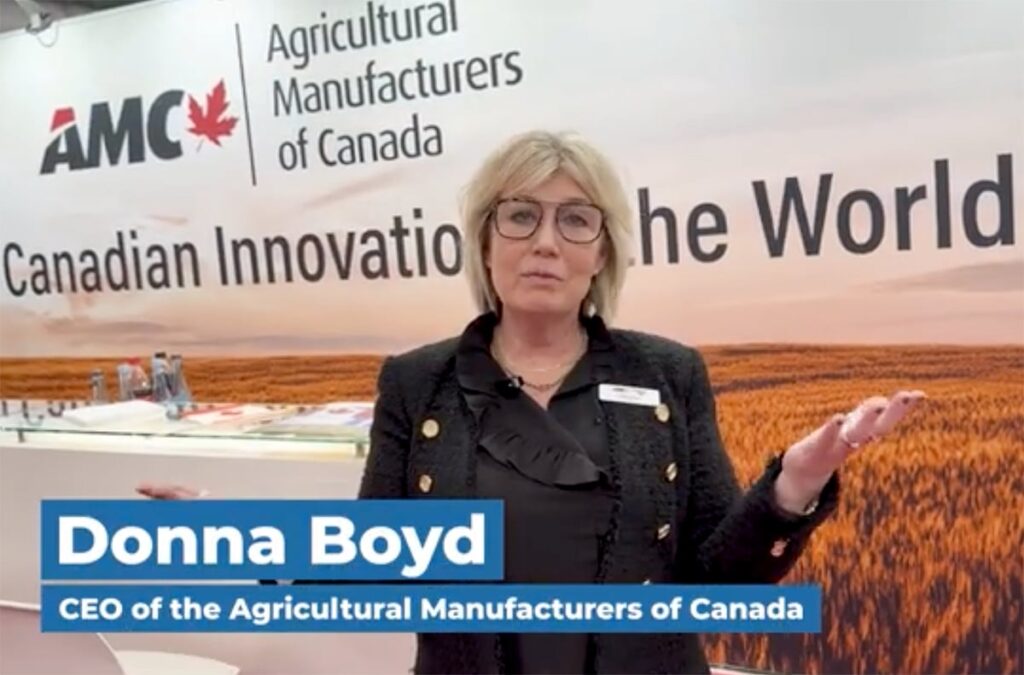 Donna Boyd, CEO of the Agricultural Manufacturers of Canada, talks in front of the group