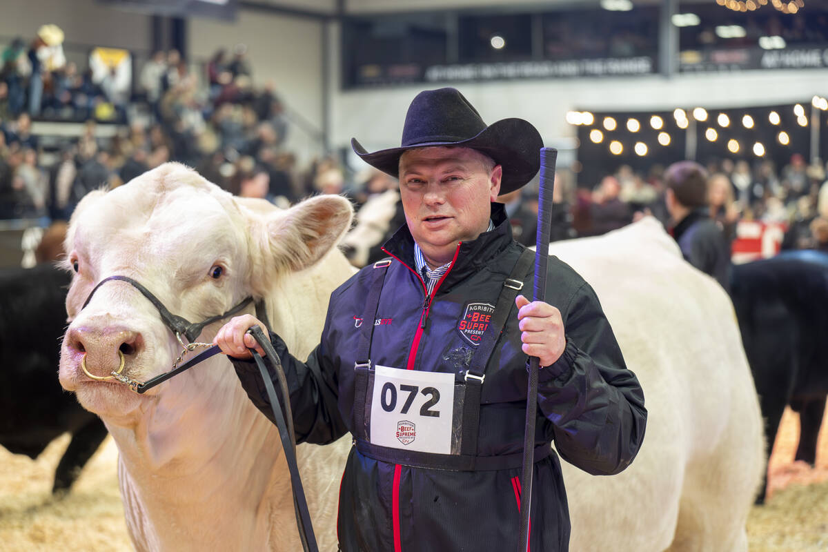 Kasey Phillips from KAY-R Land and Cattle, Waskatenau, Alta., with the supreme champion bull at Canadian Western Agribition, KAYR Tremor 7015L. The bull is co-owned with KFC Farms.