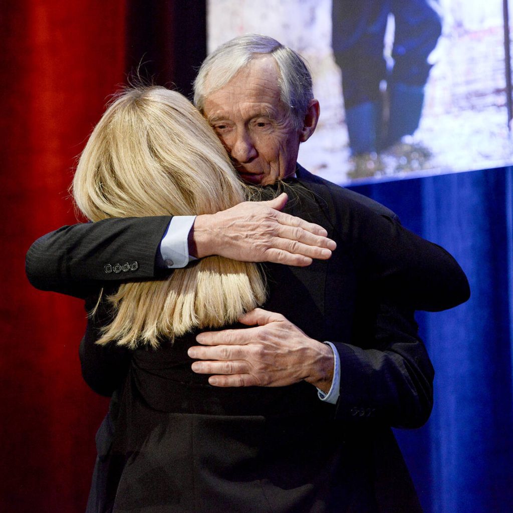 Crispin Colvin hugs Tracey Arts after being recognized for nine years of board service at the Ontario Federation of Agriculture's annual general meeting in Toronto on Nov. 26, 2025. Photo: Diana Martin