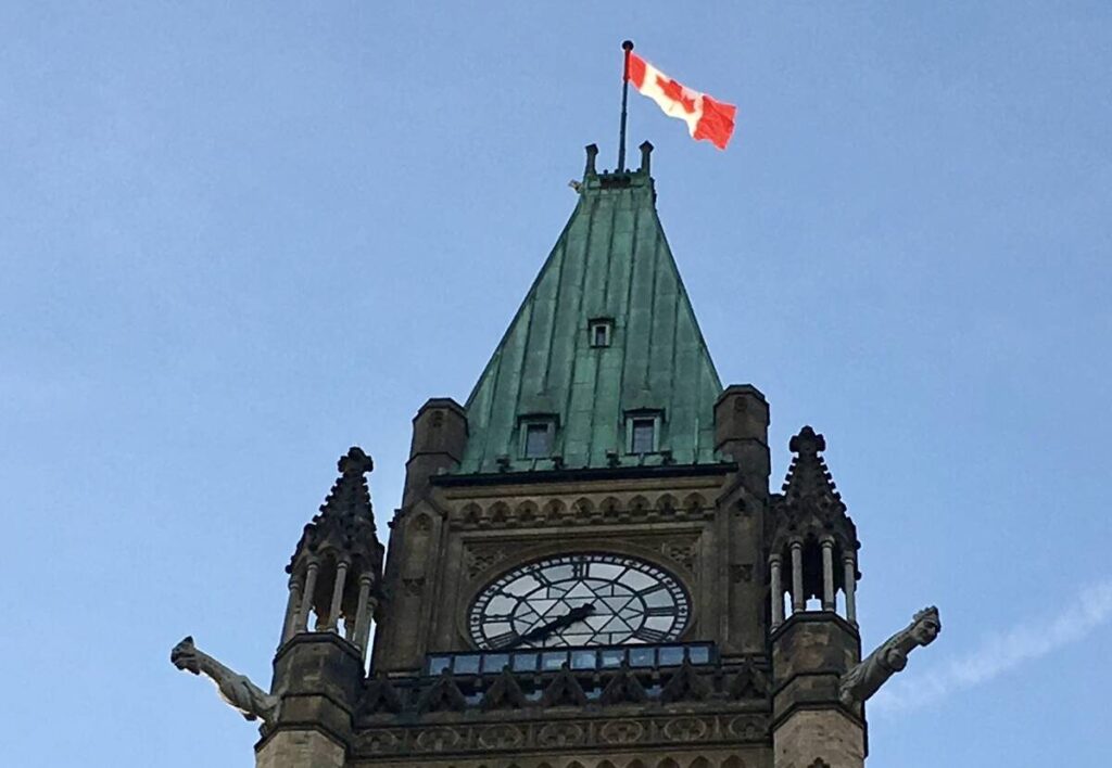 A Canadian flag flies at the top of one of the Parliament buildings in Ottawa.