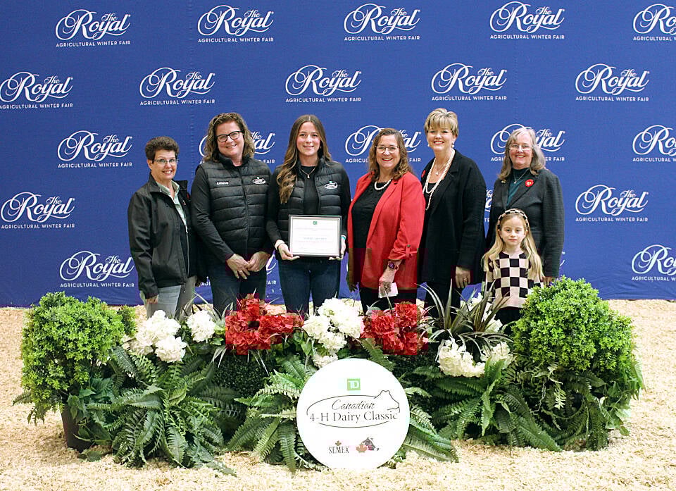 Jocelyn Lambert, centre left holding frame,  of the Middlesex 4-H Association received the 2025 Bertram and Hazel Stewart 4-H Dairy Youth Education Award and Bursary at the Royal Agricultural Winter Fair in Toronto on November 11. Photo: 4-H Canada