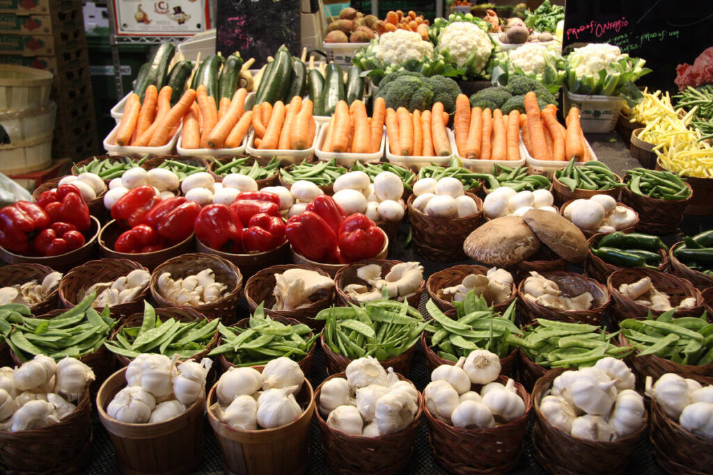A variety of vegetables are neatly displayed for sale at a market.