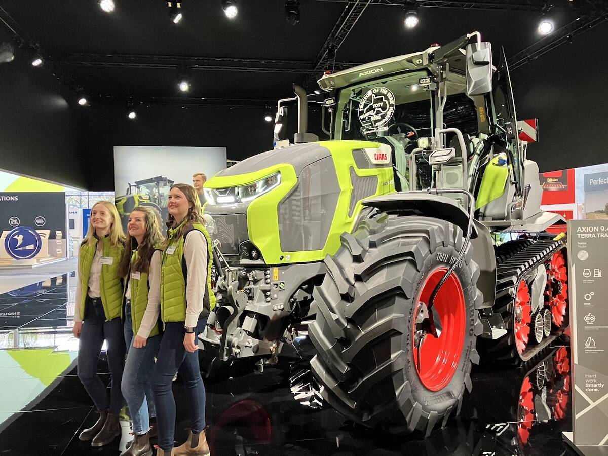 Claas team members pose by the Axion 9.450 Terra Trac tractor at Agritechnica 2025.