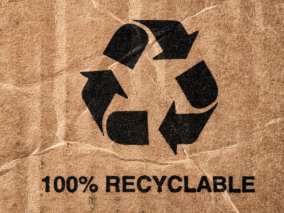 A 100% Recyclable message below a large recycling symbol on cardboard packaging.