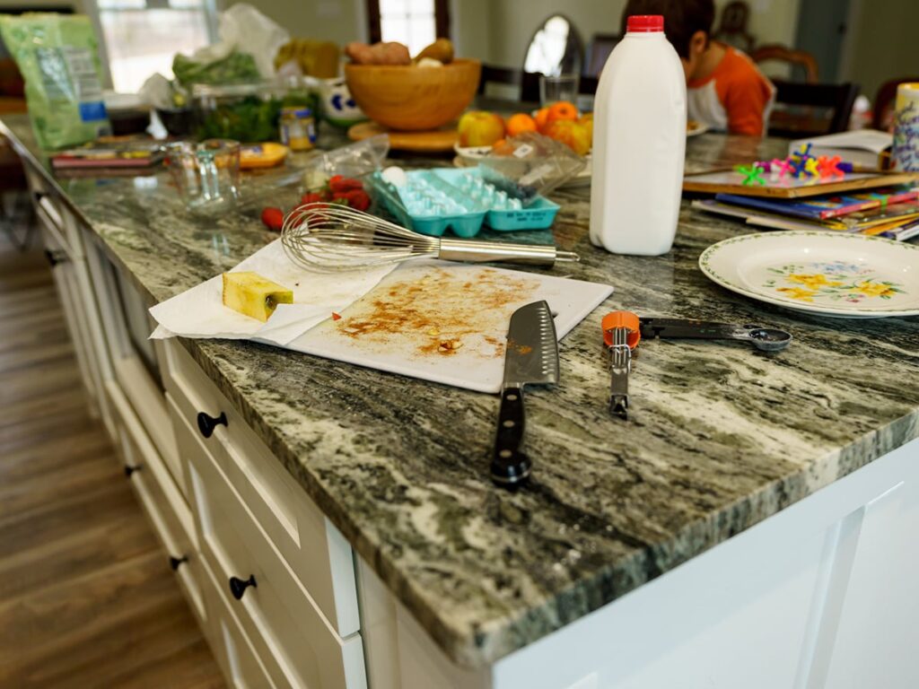 A kitchen island with the mess left following meal preparation left untouched.