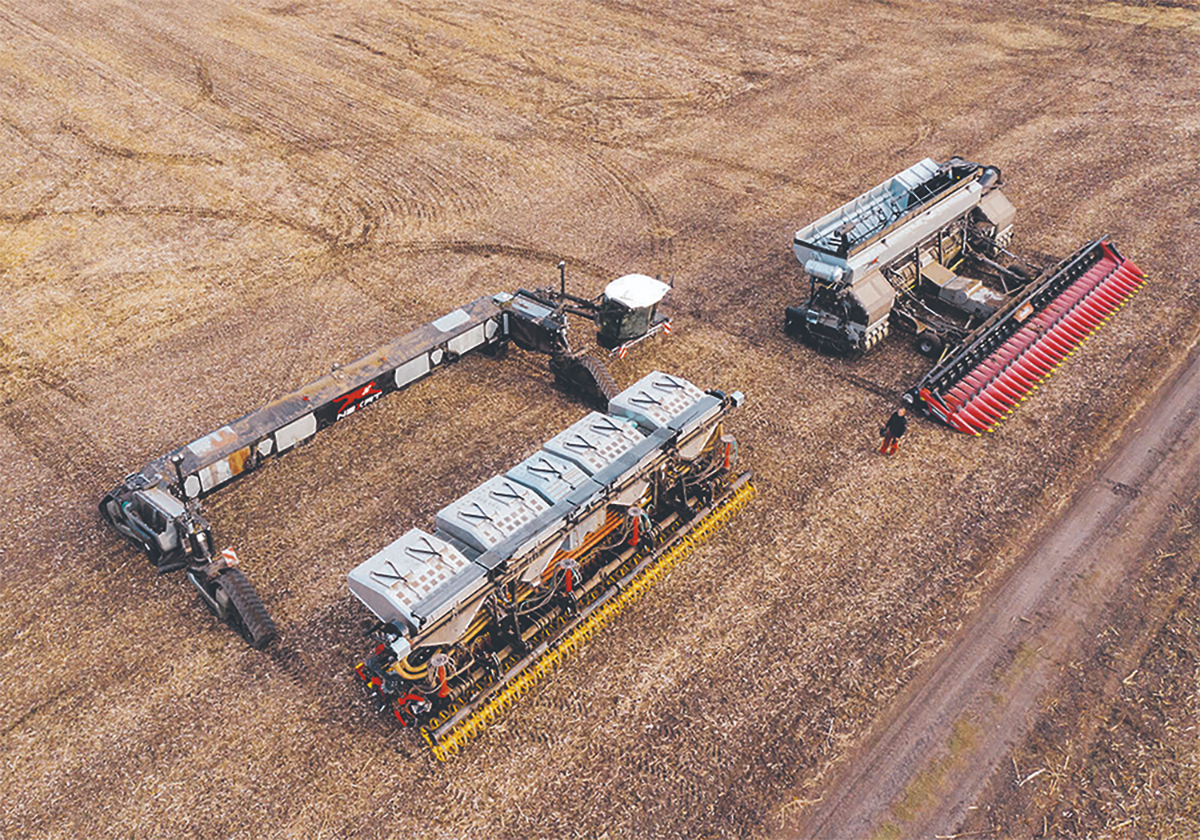 An aerial view of a NEXAT carrier system with both seeding and harvesting modules nearby.