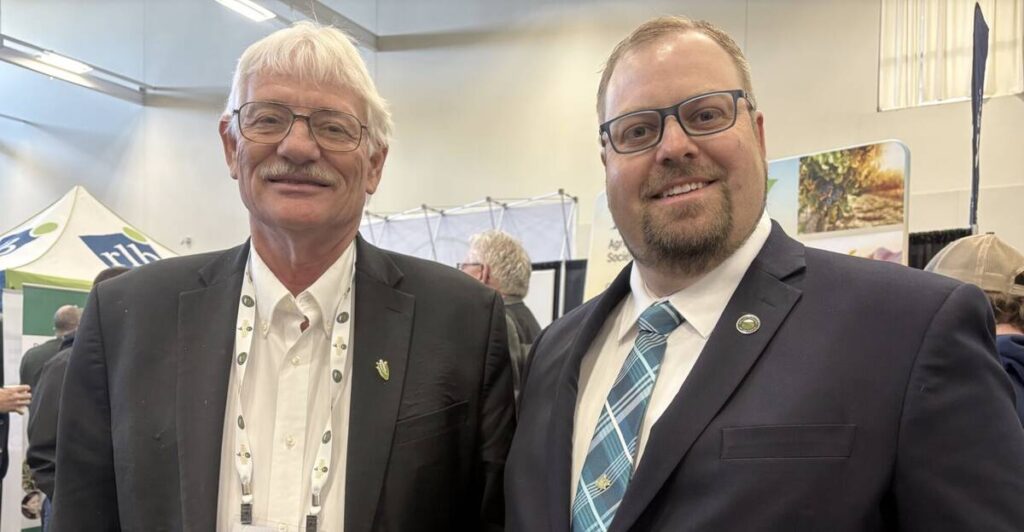 Chairman of the U.S. National Corn Growers Association, Ken Hartman, chats with Grain Farmers of Ontario vice chair Josh Boersen during a break at the organization