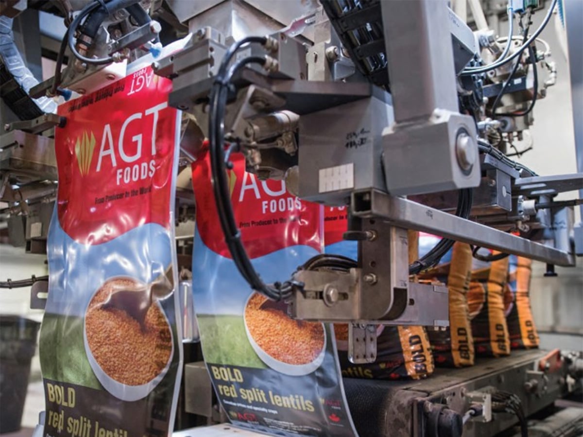 A branded bag is filled with red split lentils on a production line at an AGT Foods production facility.