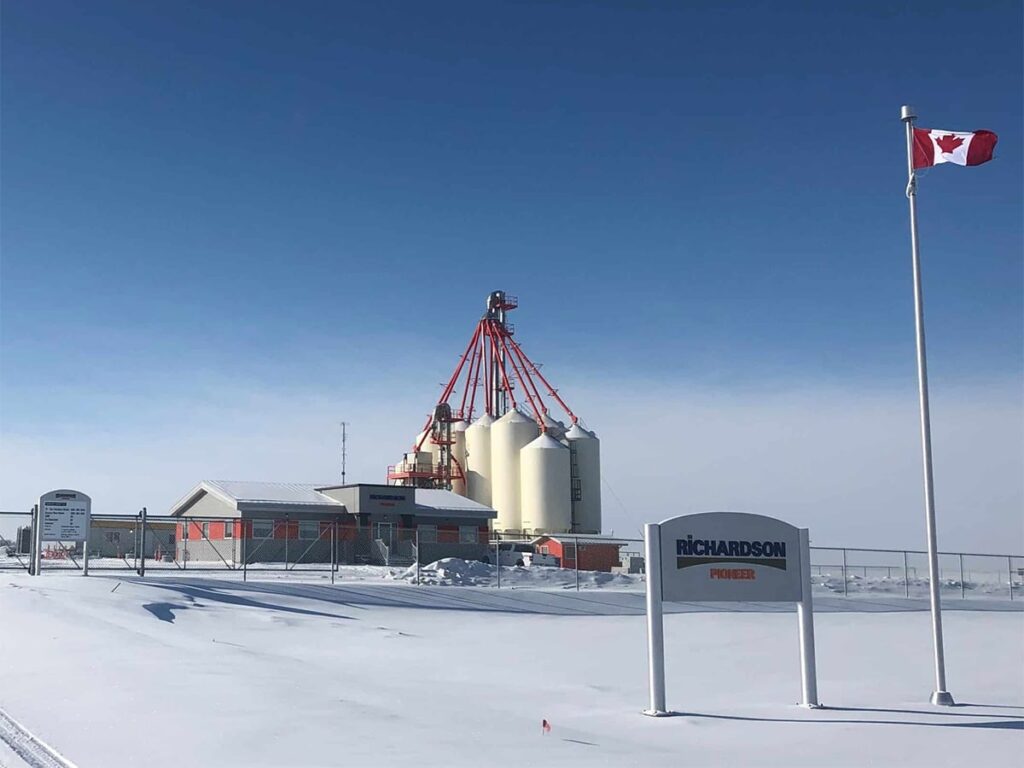 A screencap of the Richardson International facility near Delsile, Saskatchewan, in winter with a clear blue sky overhead.