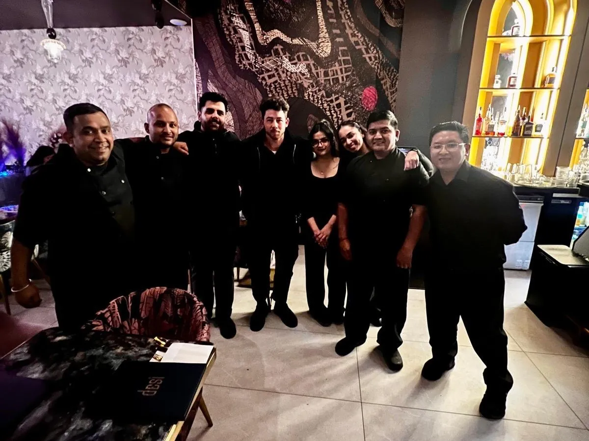 Nick Jonas (fourth from left) with staff at Desi Indian Lounge in Vancouver. 