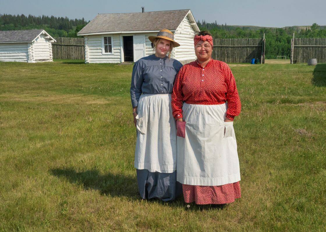 Two women re-enactors dressed in period costumes at Fort Walsh National Historic Site, Saskatchewan, Canada.