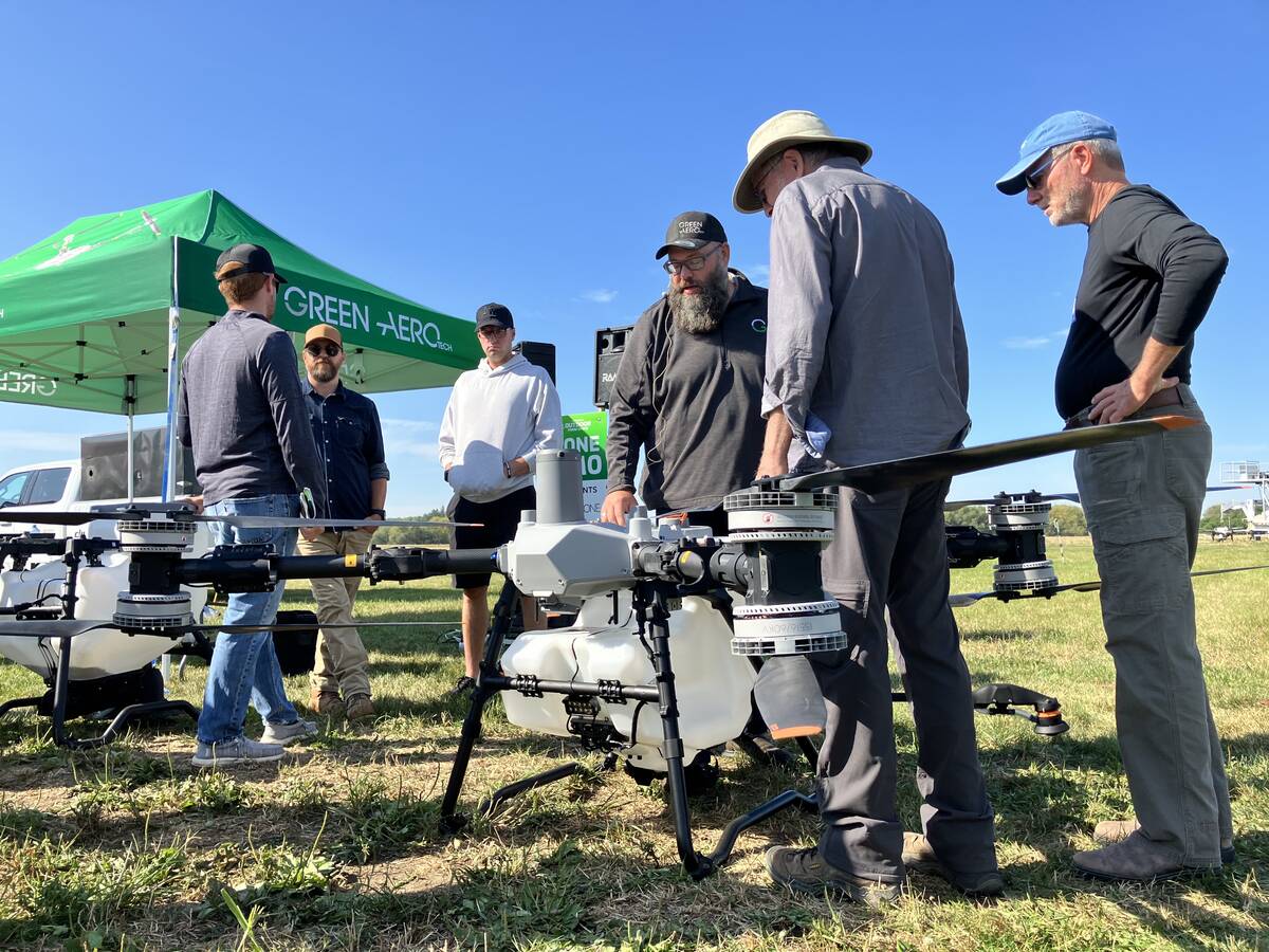 Warren Genick (centre) of Green Aero Tech with attendees at Canada’s Outdoor Farm Show in Woodstock, Ont., in September 2025.  Photo: Greg Berg