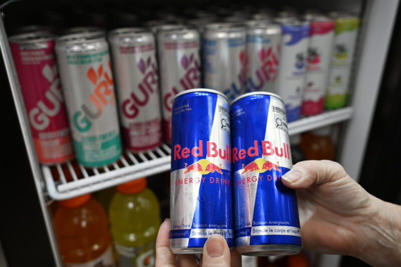 A pharmacy employee pulls out all the energy drinks from their refrigerator after receiving a suggestion from the Ordre des Pharmaciens du Quebec, to stop selling them, in connection with the death of Zachary Miron, a young man who died after taking an energy drink, in Levis, Que. Wednesday, May 6, 2026. THE CANADIAN PRESS/Jacques Boissinot