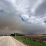 A massive plume of smoke fills the sky looking east along Highway 3 near Shellbrook, Saskatchewan.